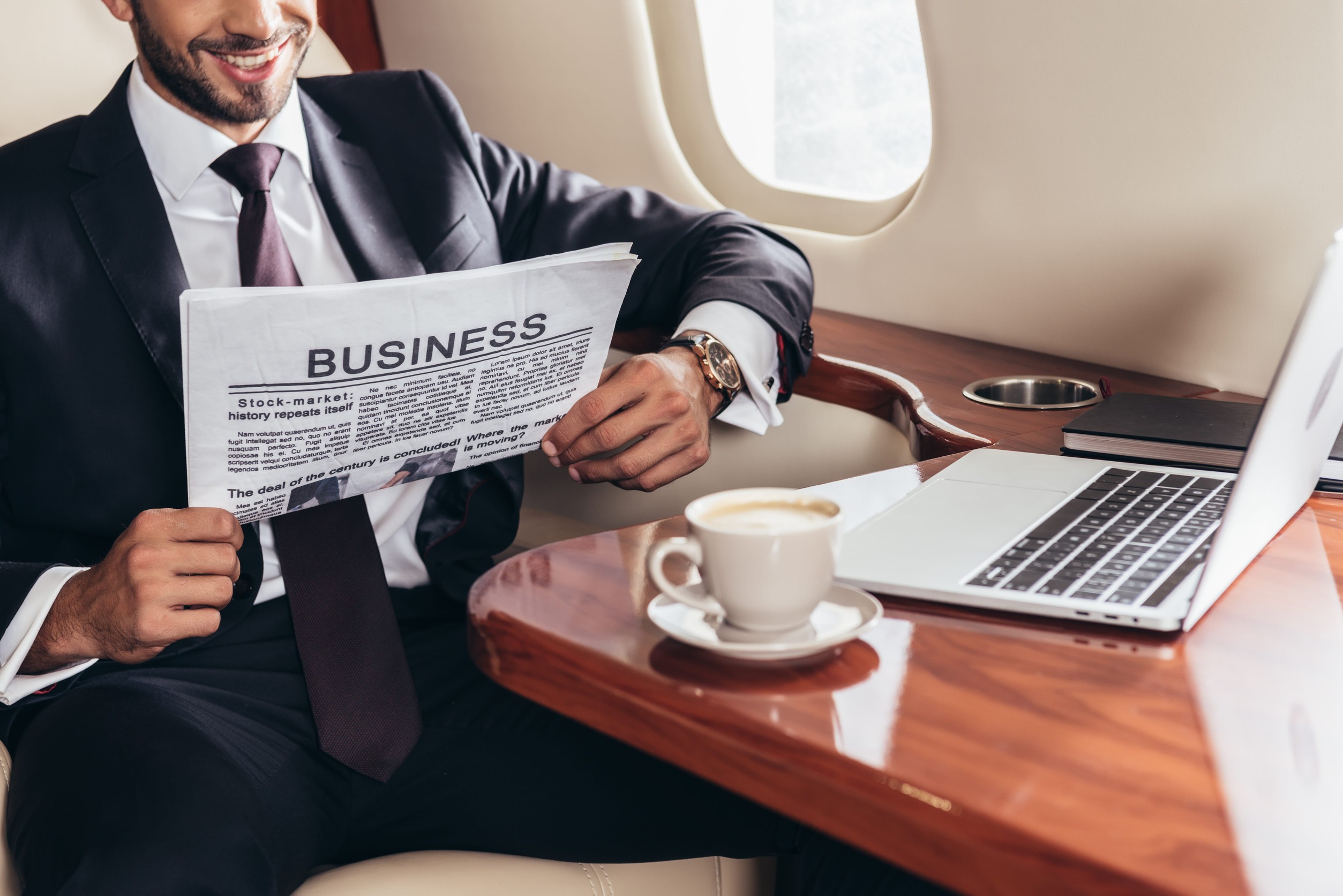 Businessman In Suit Reading Business Newspaper