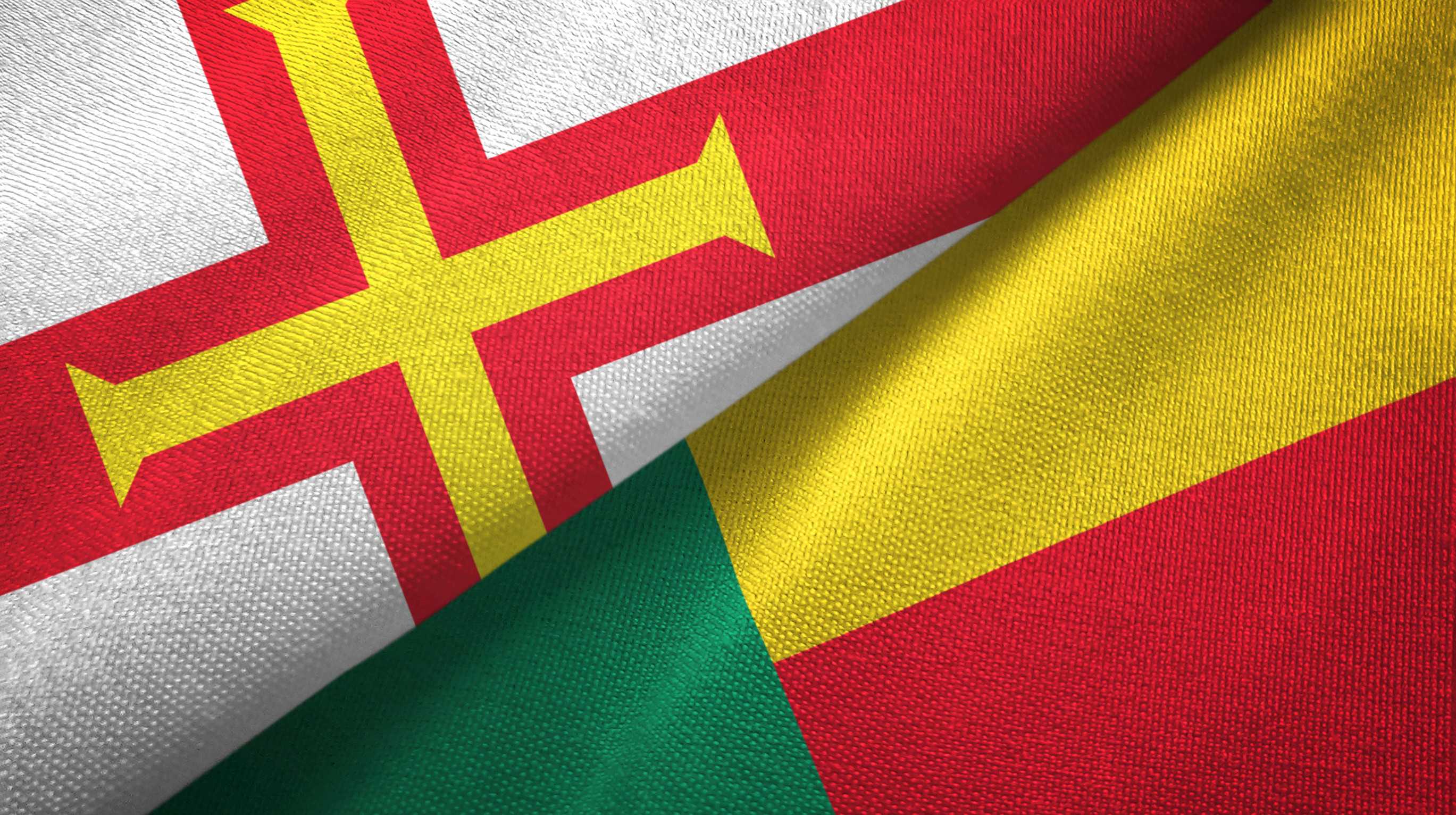 Guernsey And Benin Two Folded Flags Together